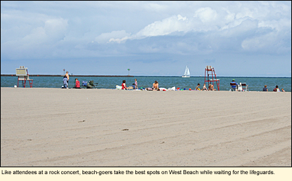 Like attendees at a rock concert, beach-goers take the best spots on West beach while waiting for the lifeguards.